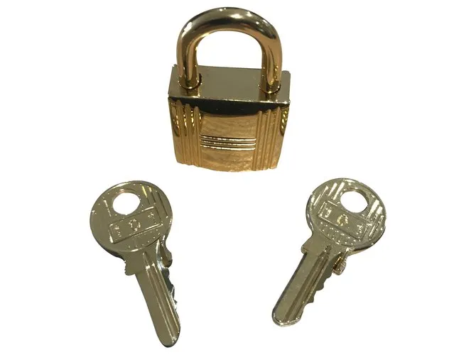 Candado de acero dorado Hermès con 2 llaves 