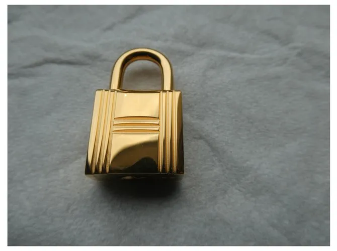 Candado de acero dorado Hermès con 2 llaves 