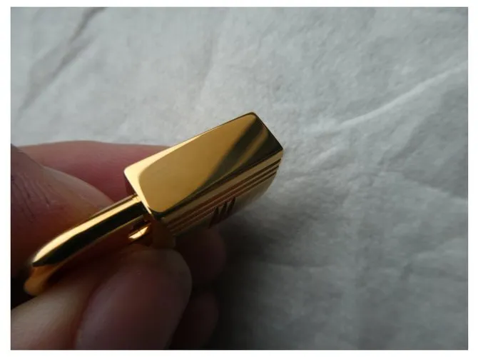 Candado de acero dorado Hermès con 2 llaves 
