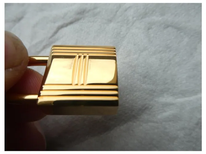 Candado de acero dorado Hermès con 2 llaves 